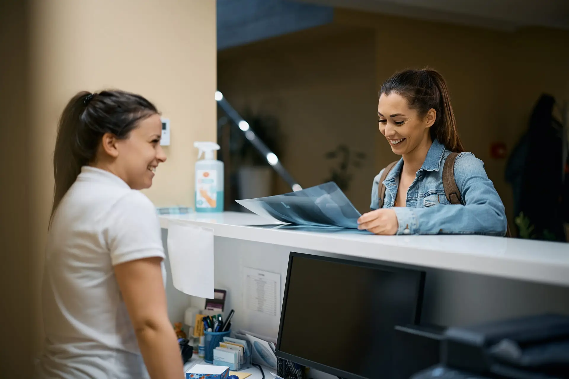 5 reasons to consider partnering with a physical therapy group happy woman looking at her x ray image at receptio 2022 11 29 22 43 08 utc scaled 5 reasons to consider partnering with a physical therapy group